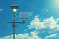 Antique Street Lamp Illuminated with Solar Panel Under Blue Sky with Clouds Royalty Free Stock Photo