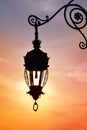 Antique street lamp lantern over sunset sky Royalty Free Stock Photo