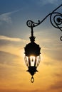 Antique street lamp lantern over sunset sky Royalty Free Stock Photo