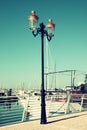 Antique street lamp with yacht. vintage filtered image Royalty Free Stock Photo