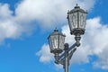 Antique street lamps against the blue sky Royalty Free Stock Photo