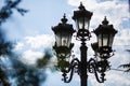 Antique street lamps in carved frames during the day. Royalty Free Stock Photo