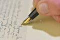 Antique style. Hand writing letter with fountain pen. Close-up of a male hand ready to write with an elegant fountain Royalty Free Stock Photo