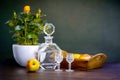 Antique stylized still life with a bouquet of roses, a decanter of alcohol and apples.