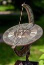 Antique sundial with a beautiful dial with numbers on the edges and the sun in the center.