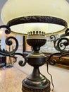 Antique table lamp on a table with a marble top. Royalty Free Stock Photo