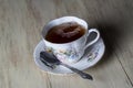 Antique Tea Cup Full of Tea on Wood Background Royalty Free Stock Photo