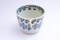 Antique tea cup restored with gold 22k. Kintsugi technique. Royalty Free Stock Photo