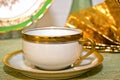 Antique teacup on saucer with fancy gold edge Royalty Free Stock Photo