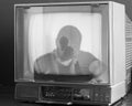 Antique television set with a silhouette of a person on the screen