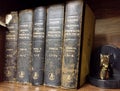 Antique textbooks on wooden shelf. Treaty of Practical Pharmacy by Hermann Hager