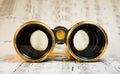 Antique theater binoculars over classical music Royalty Free Stock Photo