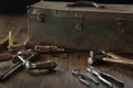 Antique tools and toolbox on dark wood surface
