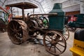 Antique tractor sits in a warehouse