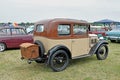 A Antique two toned coloured car on display at a show in a field Royalty Free Stock Photo