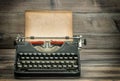 Antique typewriter with grungy worn paper page on wooden table