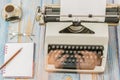 Antique typewriter with a notebook and pen with fuzzy hands