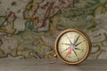 Antique Vintage Brass Compass on a Wooden Table in front of Antique Map. 3d Rendering