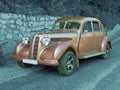 Antique vintage car (colored) on monochromatic background (road)