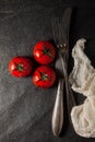 Antique, vintage cutlery withfresh grilled tomatoes decorated on a table