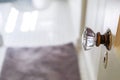 An antique vintage glass doorknob to a narrow bathroom in a small cottage house Royalty Free Stock Photo
