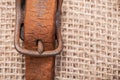 Antique vintage leather strap with oxidize brass buckle from sleigh bells on burlap