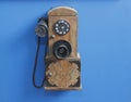 Antique, vintage phone on blue background. technology of yesteryear