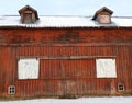 Antique vintage red gable barn with sliding doors and dormer roof windows Royalty Free Stock Photo