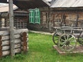 Antique vintage Russian rural peasant cart in the yard of a wooden house