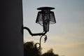 Vintage style lamppost lantern attached to wall of building. Light off