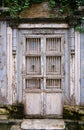 Antique vintage wooden grey door with white steel grille door.