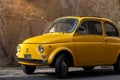 Antique vintage yellow 500 car in the streets of Trastevere in Rome, Italy Royalty Free Stock Photo