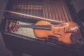 Antique violin and violin bow lying on dulcimer. Close up a violin instrument and cymbal