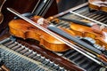 Antique violin and violin bow lying on dulcimer. Close up a violin instrument and cymbal before a concert Royalty Free Stock Photo