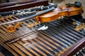 Antique violin and violin bow lying on dulcimer. Close up a violin instrument and cymbal before a concert