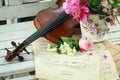 Antique violin, notes and spring bouquet