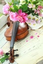 Antique violin, notes and spring bouquet