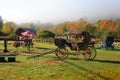 Antique wagon under colorful trees in autumn time