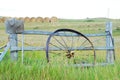 Antique wagon wheel leans against a fence in Montana.