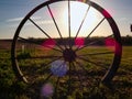 Antique Wagon Wheel Silhouetted in the Sunset Royalty Free Stock Photo