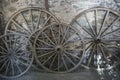 Antique Wagon Wheels Against an Old Stone Wall Royalty Free Stock Photo