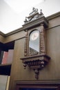 Antique wall clock with pendulum against wooden background. Royalty Free Stock Photo