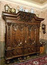 Antique wardrobe with beautiful clothing cabinet and several copper and porcelain samovars on it