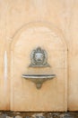 Antique wash basin with a stoned lion head and vessel sink on concrete wall Royalty Free Stock Photo