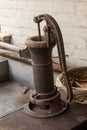 Antique water pump with a basket of clothes pins Royalty Free Stock Photo