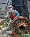 Antique Jockey Statue by Rustic Wagon Wheel Royalty Free Stock Photo