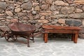 Antique wheelbarrow and bench