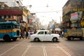 Antique white car down the busy street