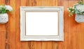 Antique white photo frame with empty space for your picture or text placed on wood plank wall background Royalty Free Stock Photo