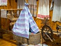 Antique wicker baby cradle in the interior of the hut